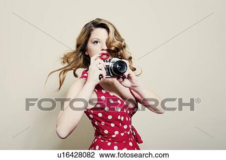 Woman taking pictures with vintage camera View Large Photo Image Stock Image - Woman taking pictures with vintage camera. Fotosearch