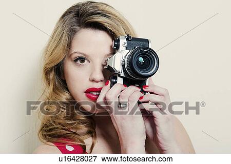 Woman taking pictures with vintage camera View Large Photo Image Stock Photo - Woman taking pictures with vintage camera. Fotosearch