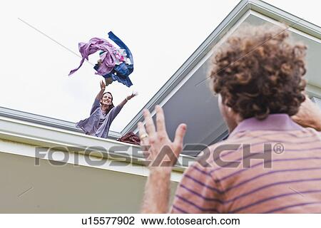 Woman throwing out boyfriends clothes View Large Photo Image Stock Image - Woman throwing out boyfriends clothes. Fotosearch
