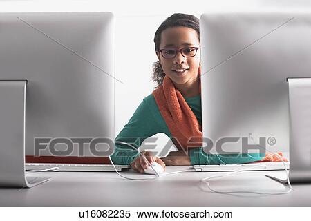 Woman using computer at desk View Large Photo Image Stock Photography - Woman using computer at desk. Fotosearch