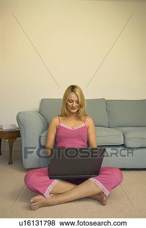 Stock Photo - Woman using laptop on floor. Fotosearch