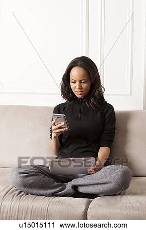 Woman using tablet computer and cell phone View Large Photo Image Stock Image - Woman using tablet computer and cell phone. Fotosearch
