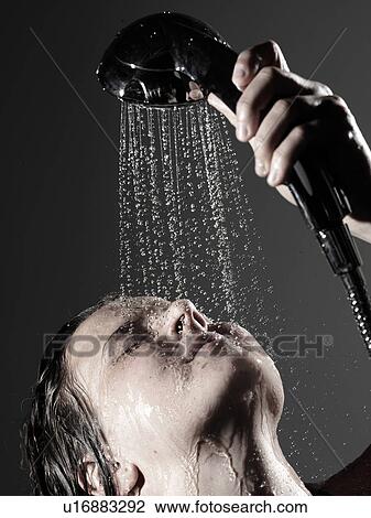 Woman washing face in shower View Large Photo Image Stock Image - Woman washing face in shower. Fotosearch
