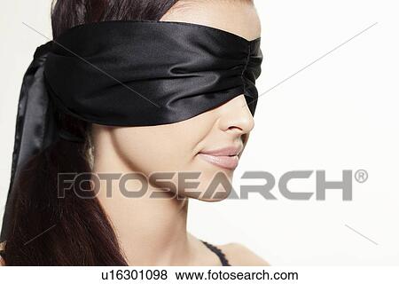 Stock Photo - Woman wearing blindfold. Fotosearch