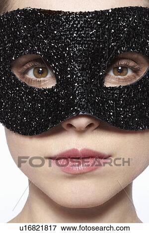 Woman wearing glitter mask over eyes View Large Photo Image Stock Photo - Woman wearing glitter mask over eyes. Fotosearch
