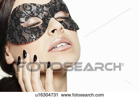 Stock Image - Woman wearing lace mask. Fotosearch