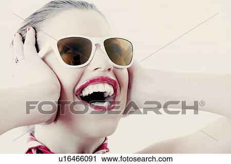 Stock Image - Woman wearing scarf and sunglasses. Fotosearch