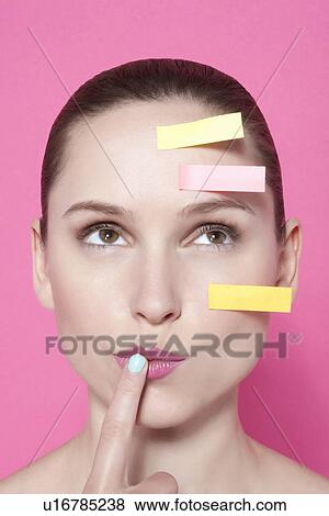 Woman with sticky notes on face View Large Photo Image Stock Photo - Woman with sticky notes on face. Fotosearch