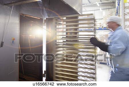Worker baking biscuits in factory View Large Photo Image Stock Image - Worker baking biscuits in factory. Fotosearch