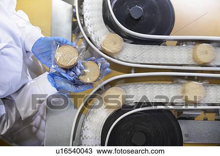 Worker checking production line in factory View Large Photo Image Stock Image - Worker checking production line in factory. Fotosearch