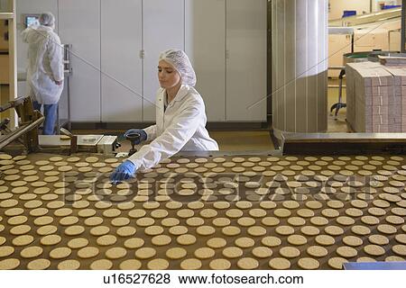 Stock Photo - Worker checking production line in factory. Fotosearch