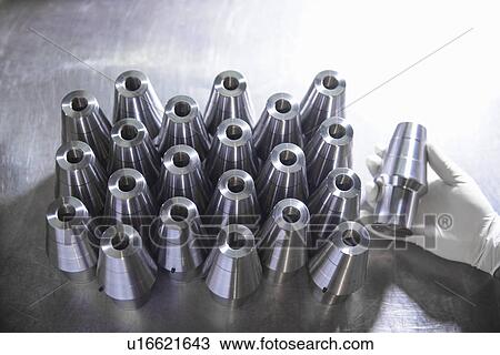 Worker holding steel part in factory View Large Photo Image Stock Image - Worker holding steel part in factory. Fotosearch