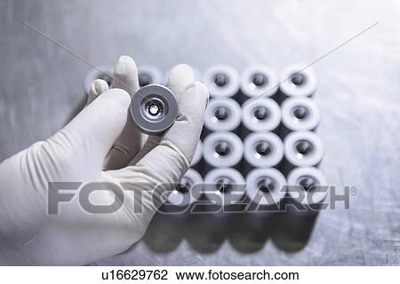 Worker holding steel part in factory View Large Photo Image Stock Image - Worker holding steel part in factory. Fotosearch