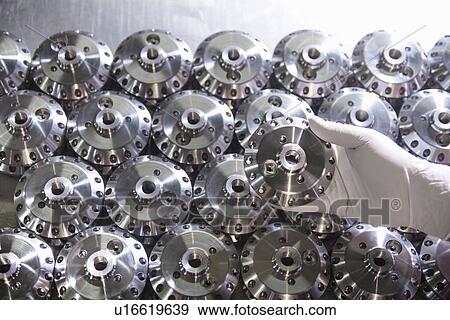Worker holding steel part in factory View Large Photo Image Stock Photo - Worker holding steel part in factory. Fotosearch
