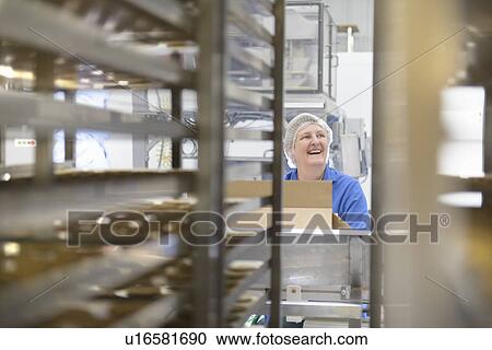 Worker packing in biscuit factory View Large Photo Image Stock Image - Worker packing in biscuit factory. Fotosearch