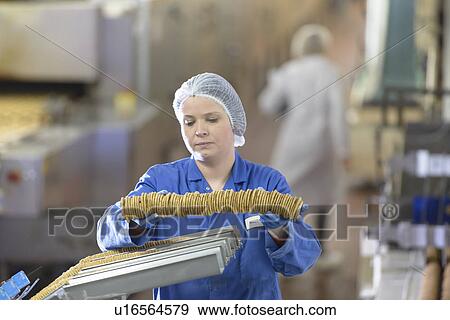 Worker packing in biscuit factory View Large Photo Image Stock Photo - Worker packing in biscuit factory. Fotosearch