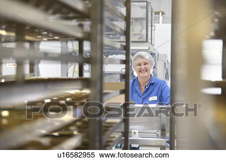 Stock Photography - Worker packing in biscuit factory. Fotosearch