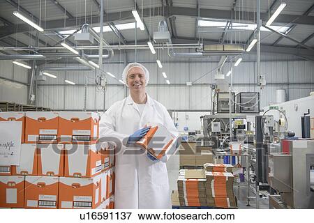 Worker smiling in biscuit factory View Large Photo Image Stock Photo - Worker smiling in biscuit factory. Fotosearch