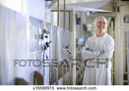 Worker smiling in biscuit factory View Large Photo Image Stock Photography - Worker smiling in biscuit factory. Fotosearch