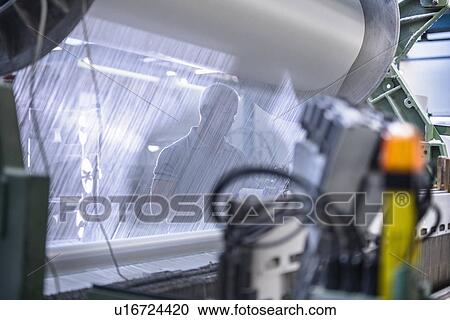 Worker using loom in textile mill View Large Photo Image Stock Image - Worker using loom in textile mill. Fotosearch