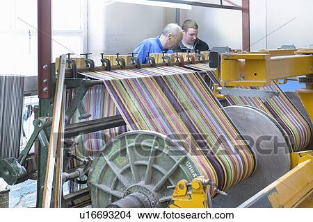 Worker using looms in textile mill View Large Photo Image Picture - Worker using looms in textile mill. Fotosearch