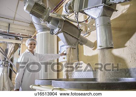 Picture - Worker with machinery in biscuit factory. Fotosearch