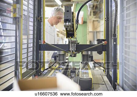 Worker with machinery in biscuit factory View Large Photo Image Stock Photograph - Worker with machinery in biscuit factory. Fotosearch