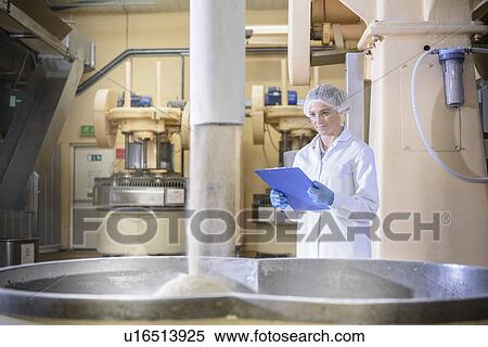Stock Photography - Worker with machinery in biscuit factory. Fotosearch