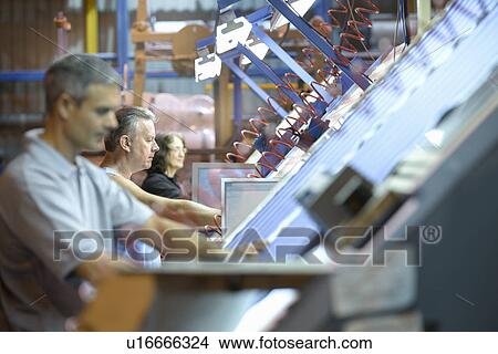 Workers examining loom in textile mill View Large Photo Image Picture - Workers examining loom in textile mill. Fotosearch
