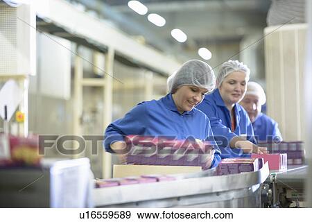 Stock Photo - Workers packing in biscuit factory. Fotosearch