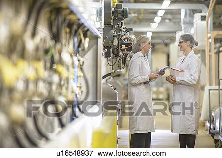 Workers talking in biscuit factory View Large Photo Image Stock Photo - Workers talking in biscuit factory. Fotosearch