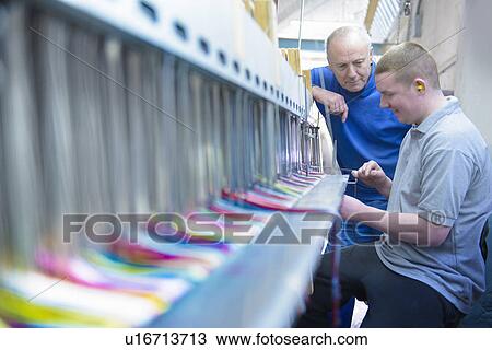 Workers using loom in textile mill View Large Photo Image Stock Image - Workers using loom in textile mill. Fotosearch