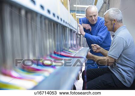 Workers using loom in textile mill View Large Photo Image Stock Image - Workers using loom in textile mill. Fotosearch