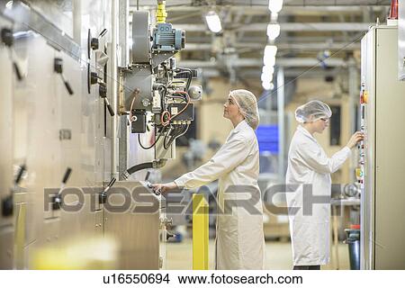 Workers with machinery in biscuit factory View Large Photo Image Picture - Workers with machinery in biscuit factory. Fotosearch