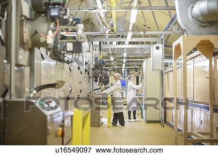 Workers with machinery in biscuit factory View Large Photo Image Stock Photo - Workers with machinery in biscuit factory. Fotosearch