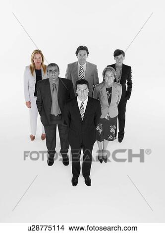 Ambitious businessman with team of professionals against white background View Large Photo Image Picture - Ambitious businessman with team of professionals against white background. Fotosearch