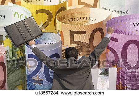 Picture - Back view of victorious businessman with briefcase against rolled up Euros. Fotosearch