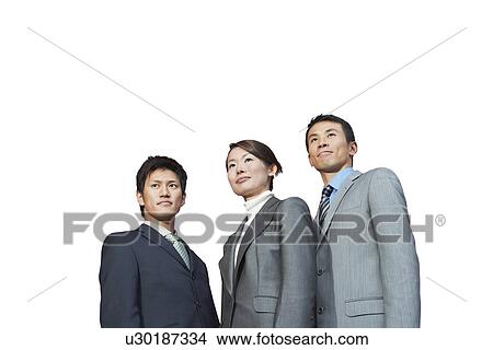 Picture - Businesspeople standing together against white background. Fotosearch