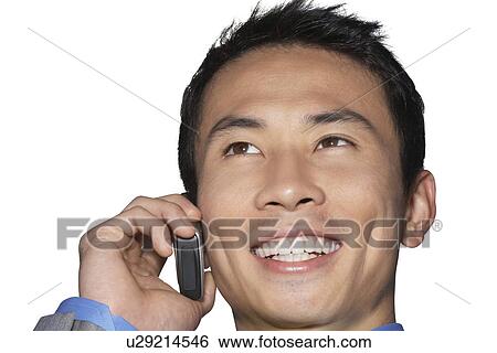 Cheerful mid-adult businessman using cell phone against white background View Large Photo Image Stock Photograph - Cheerful mid-adult businessman using cell phone against white background. Fotosearch