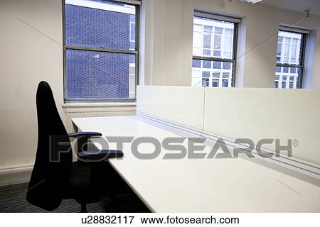 Close up of office chair and empty desk by window View Large Photo Image Stock Photo - Close up of office chair and empty desk by window. Fotosearch