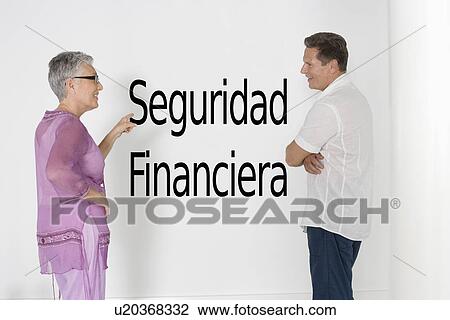 Couple discussing financial security against white wall with Spanish text "Seguridad Financiera" View Large Photo Image Stock Image - Couple discussing financial security against white wall with Spanish text "Seguridad Financiera". Fotosearch