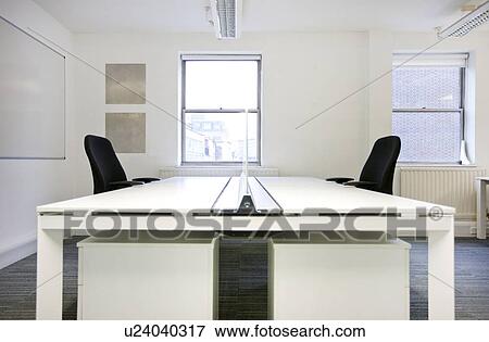 Empty office desks back to back View Large Photo Image Stock Photo - Empty office desks back to back. Fotosearch