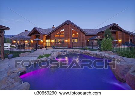 Stock Image - Entrance to a ranch home exterior at dusk. Fotosearch