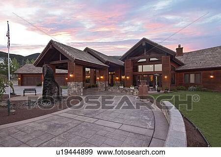 Entrance to a ranch home exterior at dusk View Large Photo Image Stock Photo - Entrance to a ranch home exterior at dusk. Fotosearch