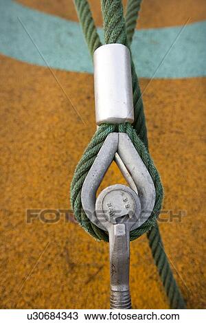 Stock Image - Eye bolt secures cable to the ground. Fotosearch