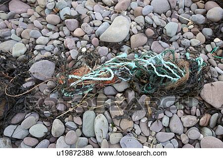 Stock Photo - Fishing refuse litters a beach. Fotosearch