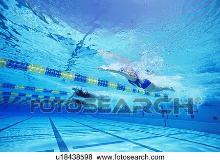Stock Photo - Group of female swimmers racing together in swimming pool. Fotosearch
