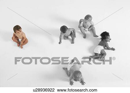 High angle view of baby girl looking at other babies crawling on floor View Large Photo Image Stock Image - High angle view of baby girl looking at other babies crawling on floor. Fotosearch