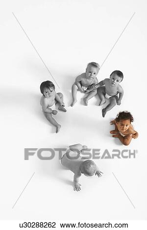 High angle view of baby girl looking up with other babies sitting on floor View Large Photo Image Stock Image - High angle view of baby girl looking up with other babies sitting on floor. Fotosearch