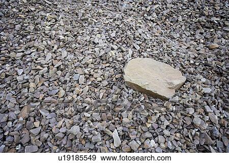 Stock Photo - Large rock sitting on pile of smaller rocks. Fotosearch
